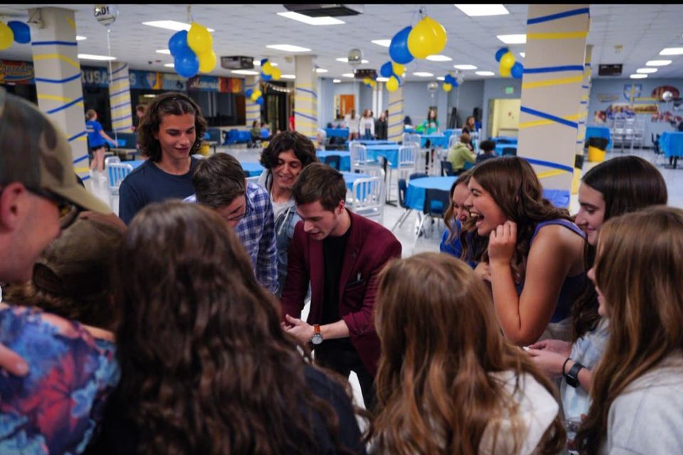 Students reacting to Caleb Hyatt during a school assembly — available in Grand Rapids