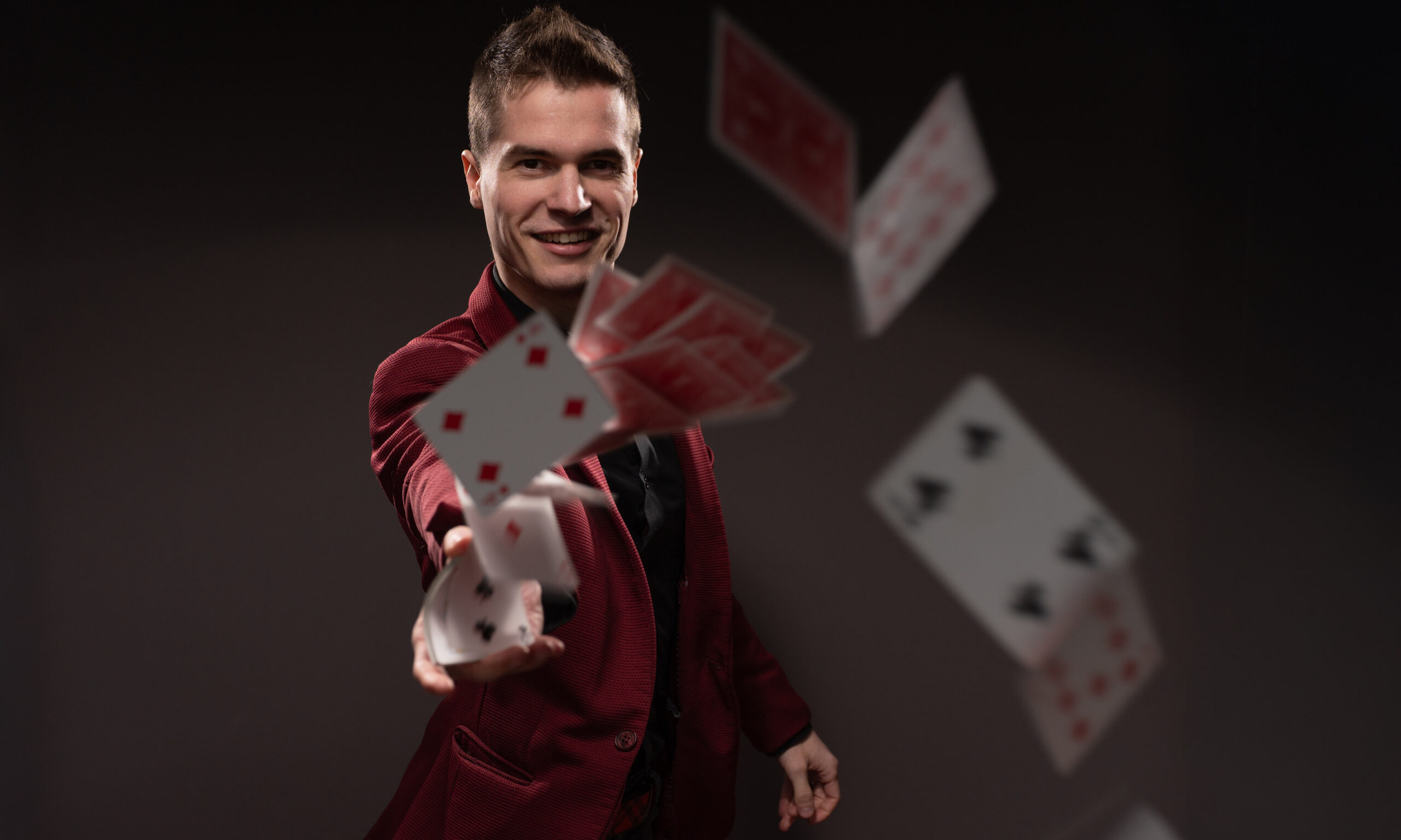 Magician Caleb Hyatt throwing playing cards
