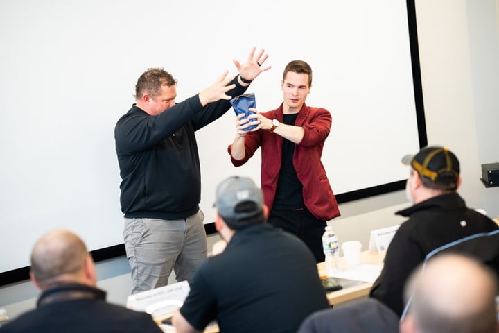 Caleb Hyatt performing interactive team building magic with adult participants