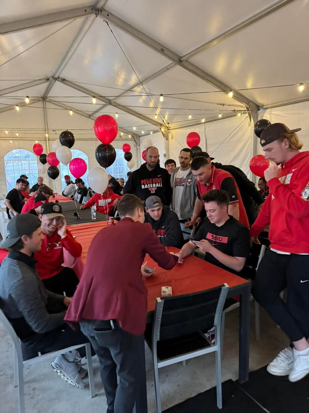 Caleb Hyatt performing card magic for guests at a private party